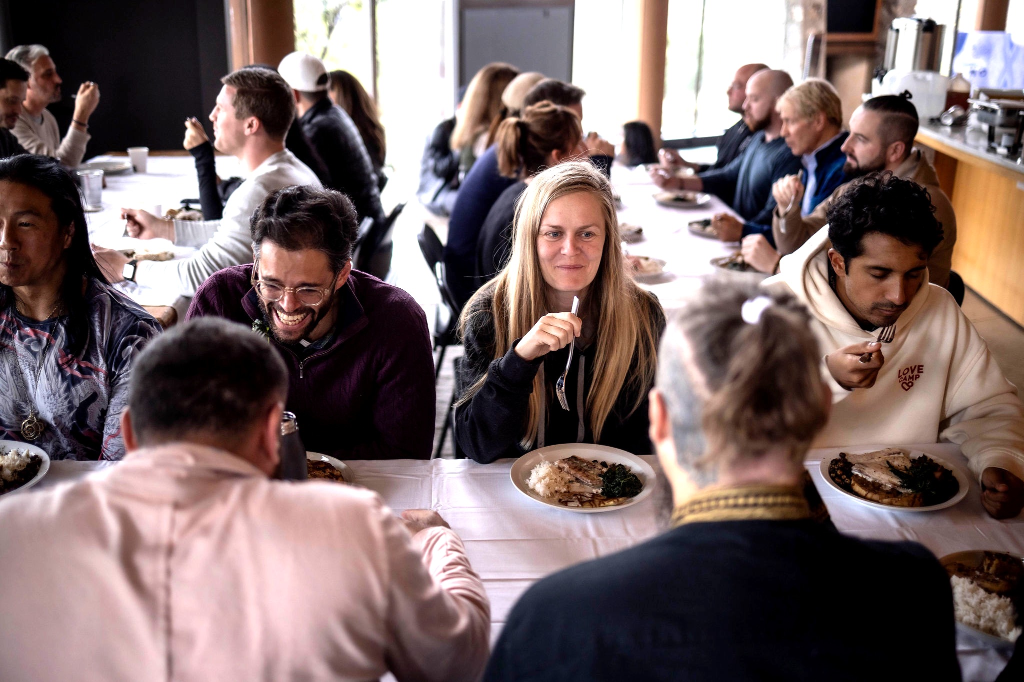 Guests gathered around a long dinner table