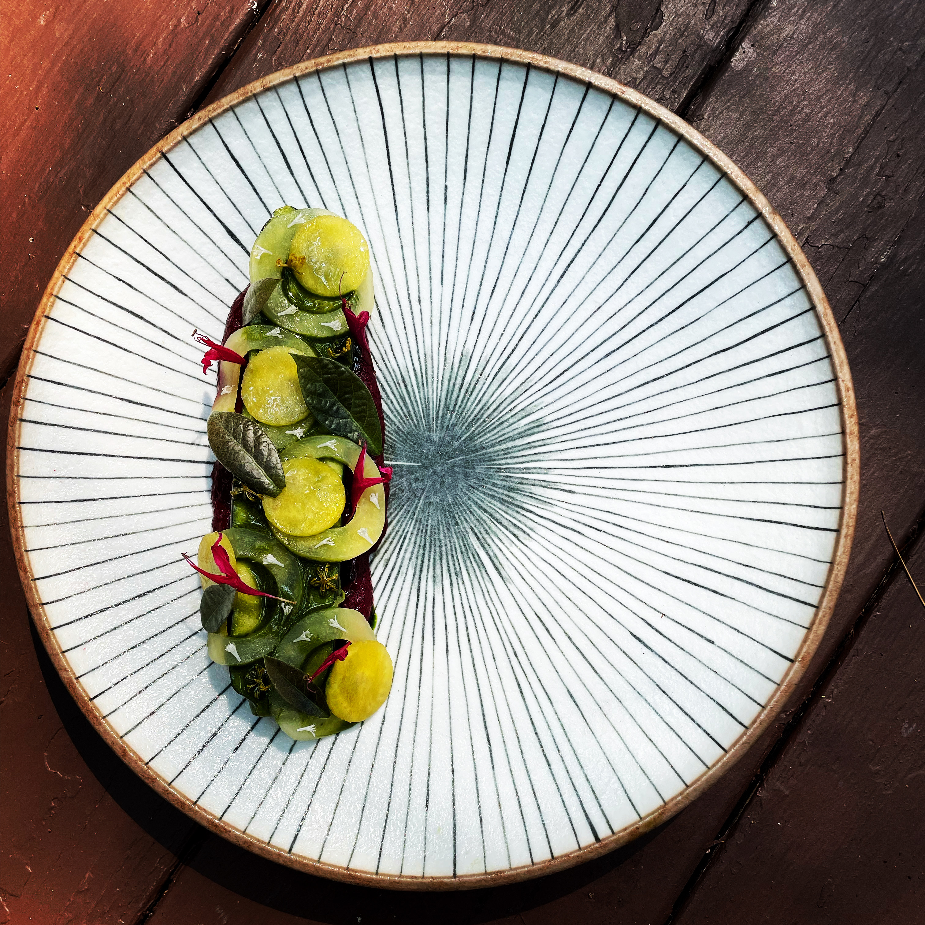 Artfully plated dish on a radial ceramic plate