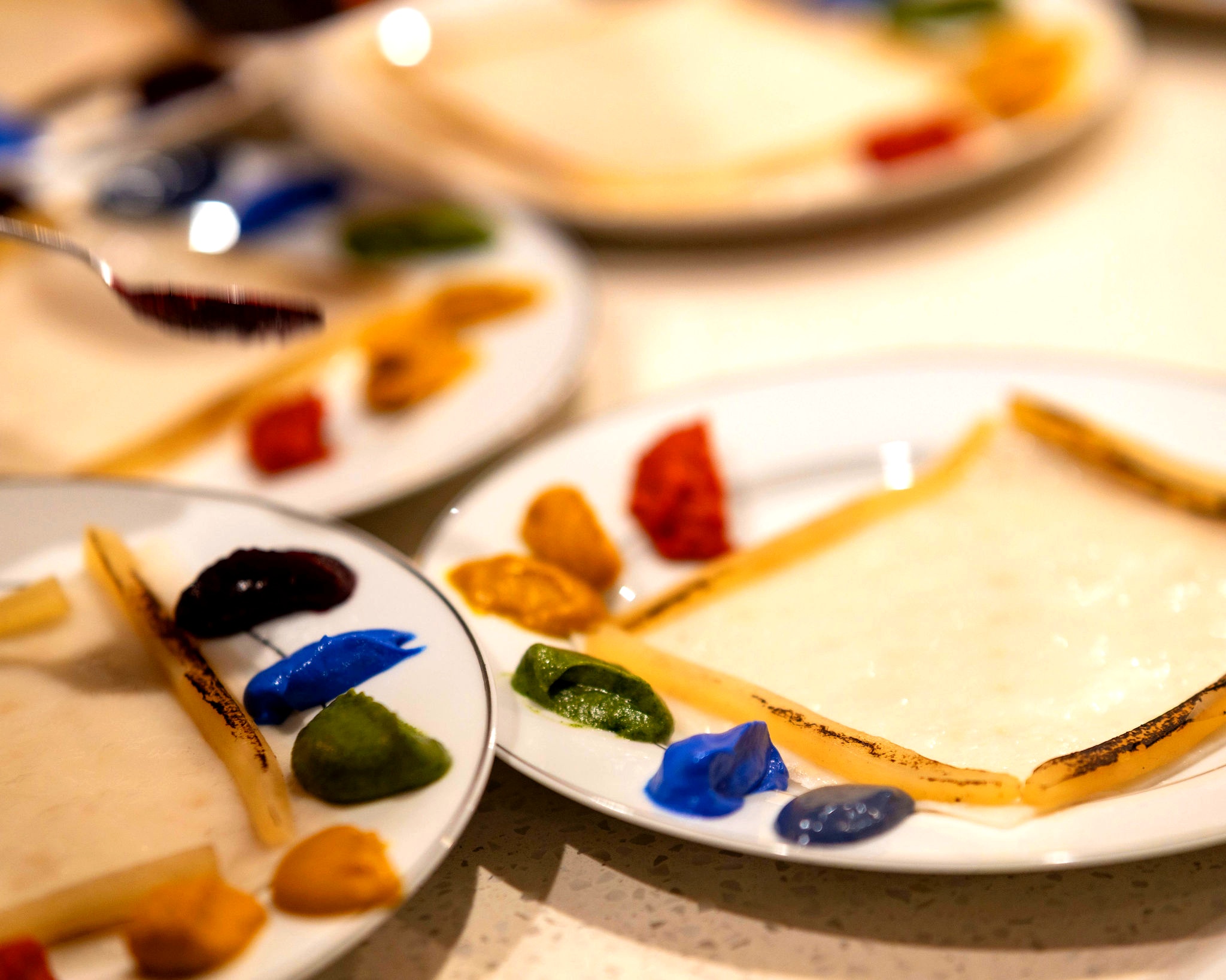 Colorful sauce dots arranged like a painter's palette