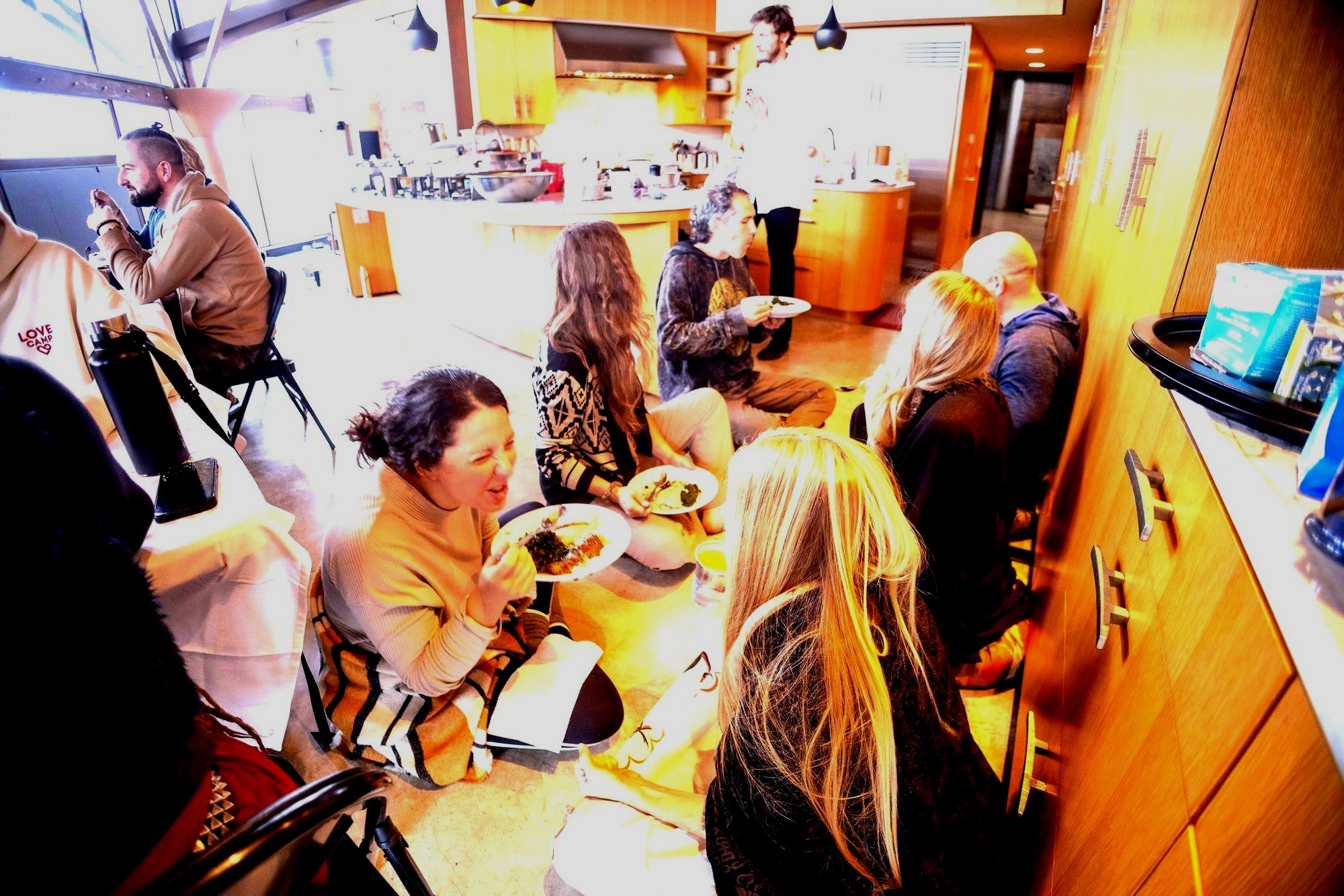 Retreat guests gathered casually on the floor eating together